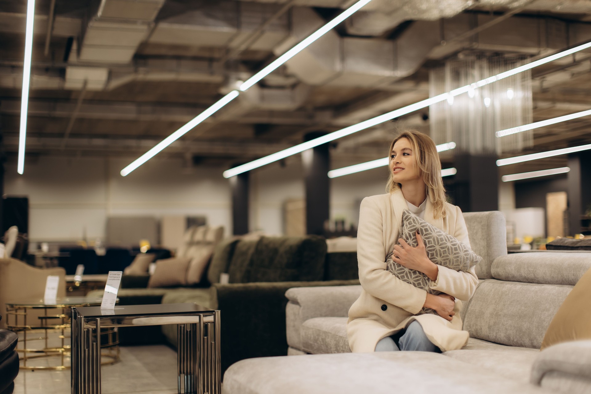 Woman Relaxing With Pillow in a Stylish Modern Furniture Store Setting